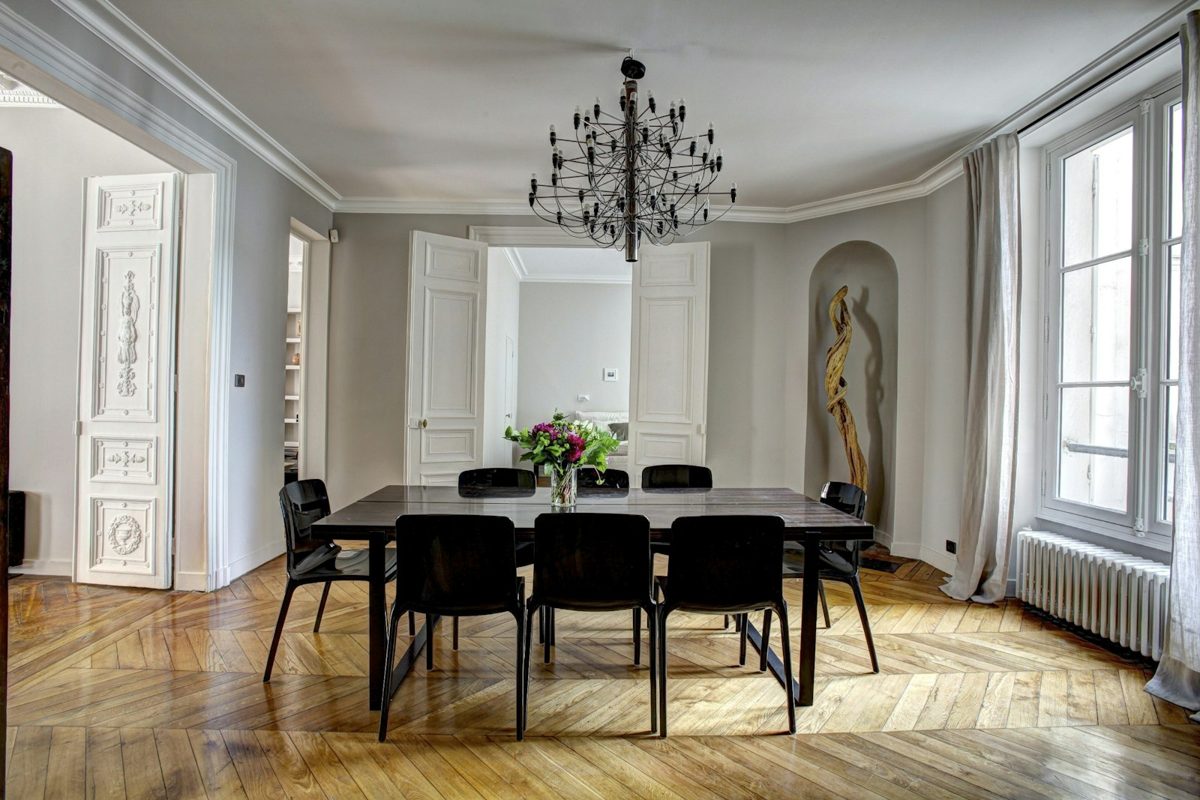 Salon d'appartement haussmannien avec moulures, parquet ancien et mobilier contemporain